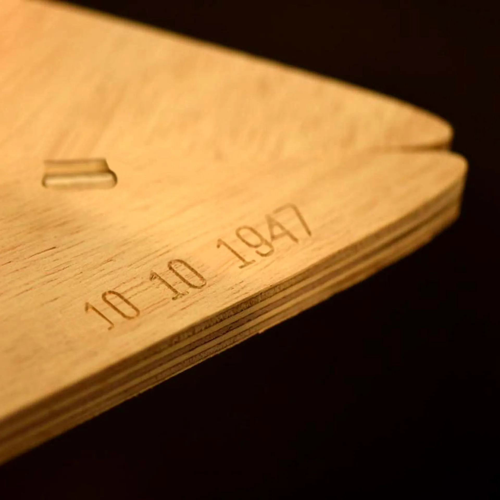Detail of the table corner with the date carved by the CNC machine.