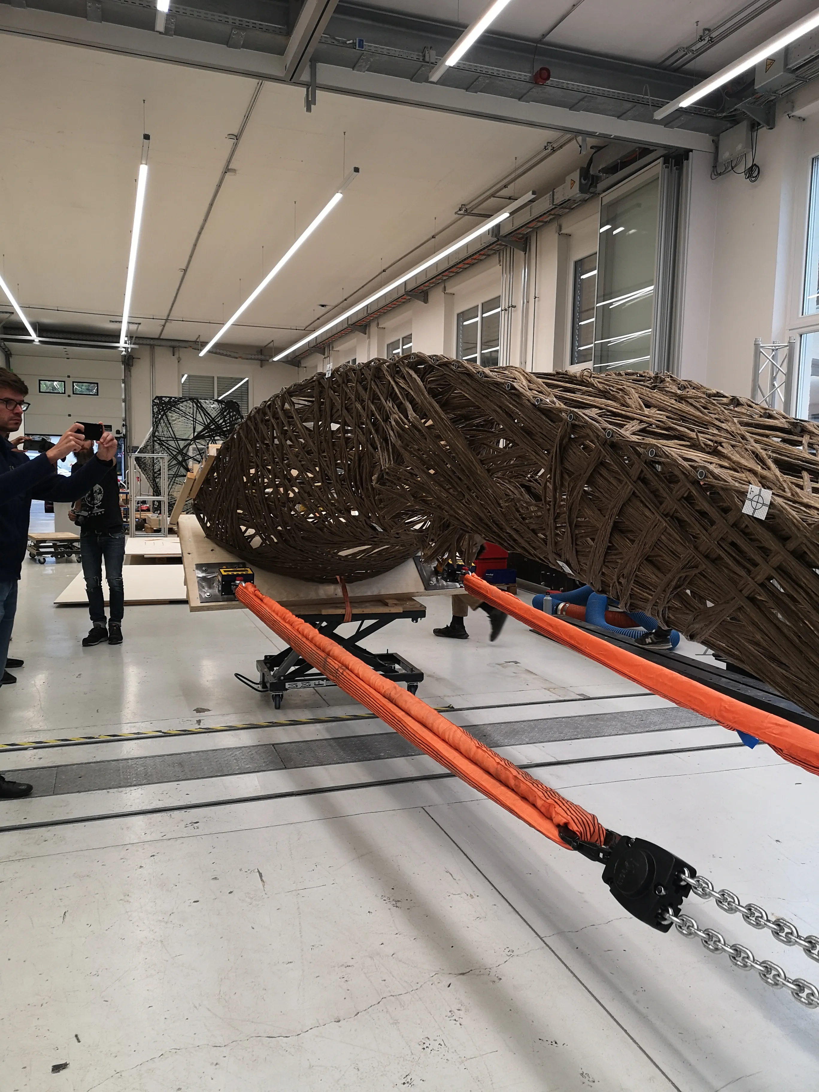 Detail of the natural fiber specimen under load, showing the density of the winding pattern.