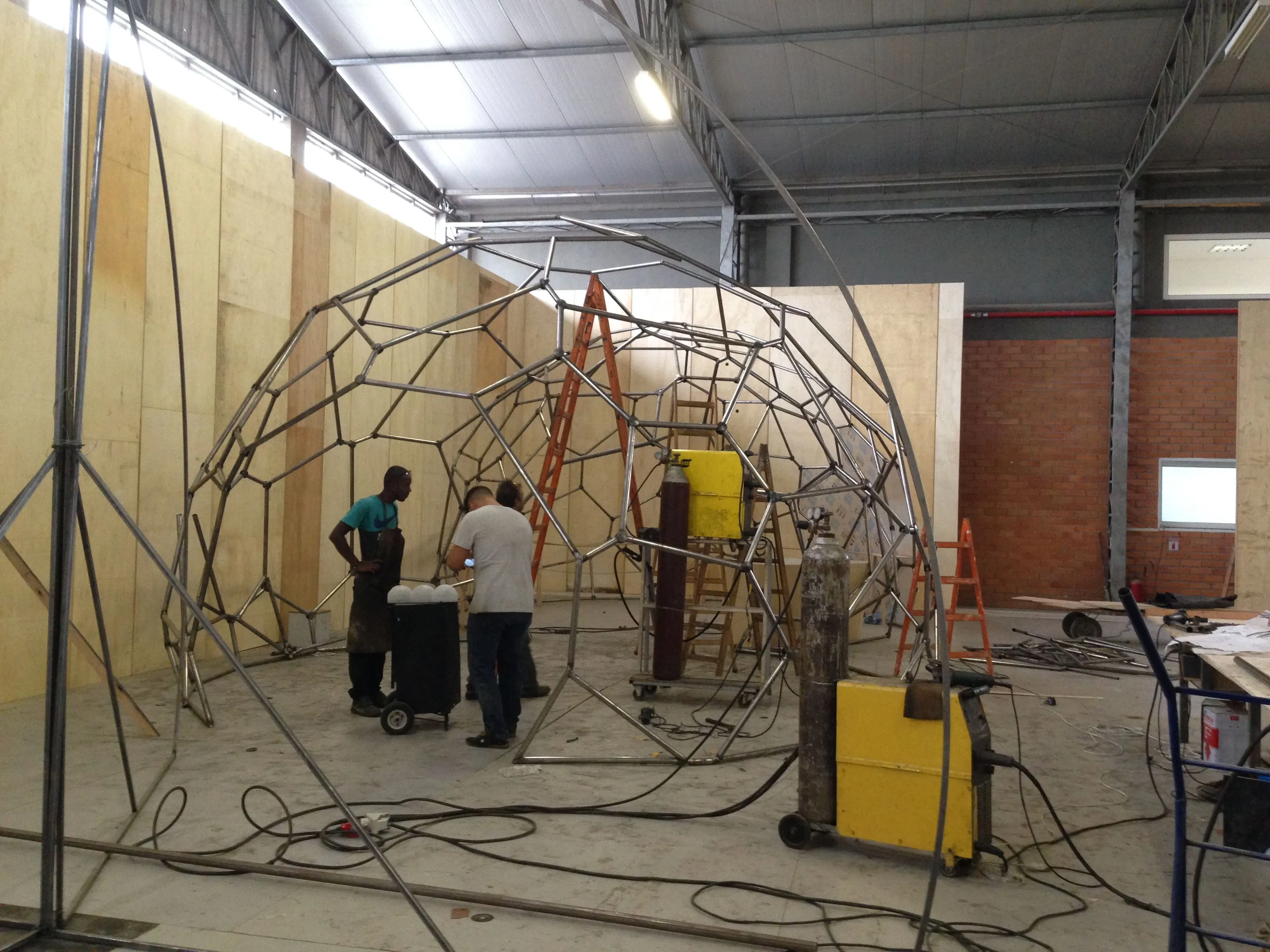 Photo of blacksmiths studying the small scale model.