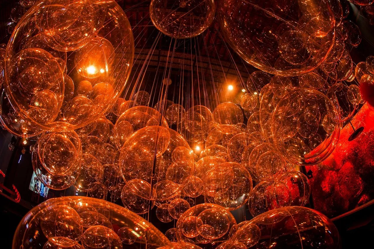 Photo showing many plastic balls and their cables connecting to the ceiling.