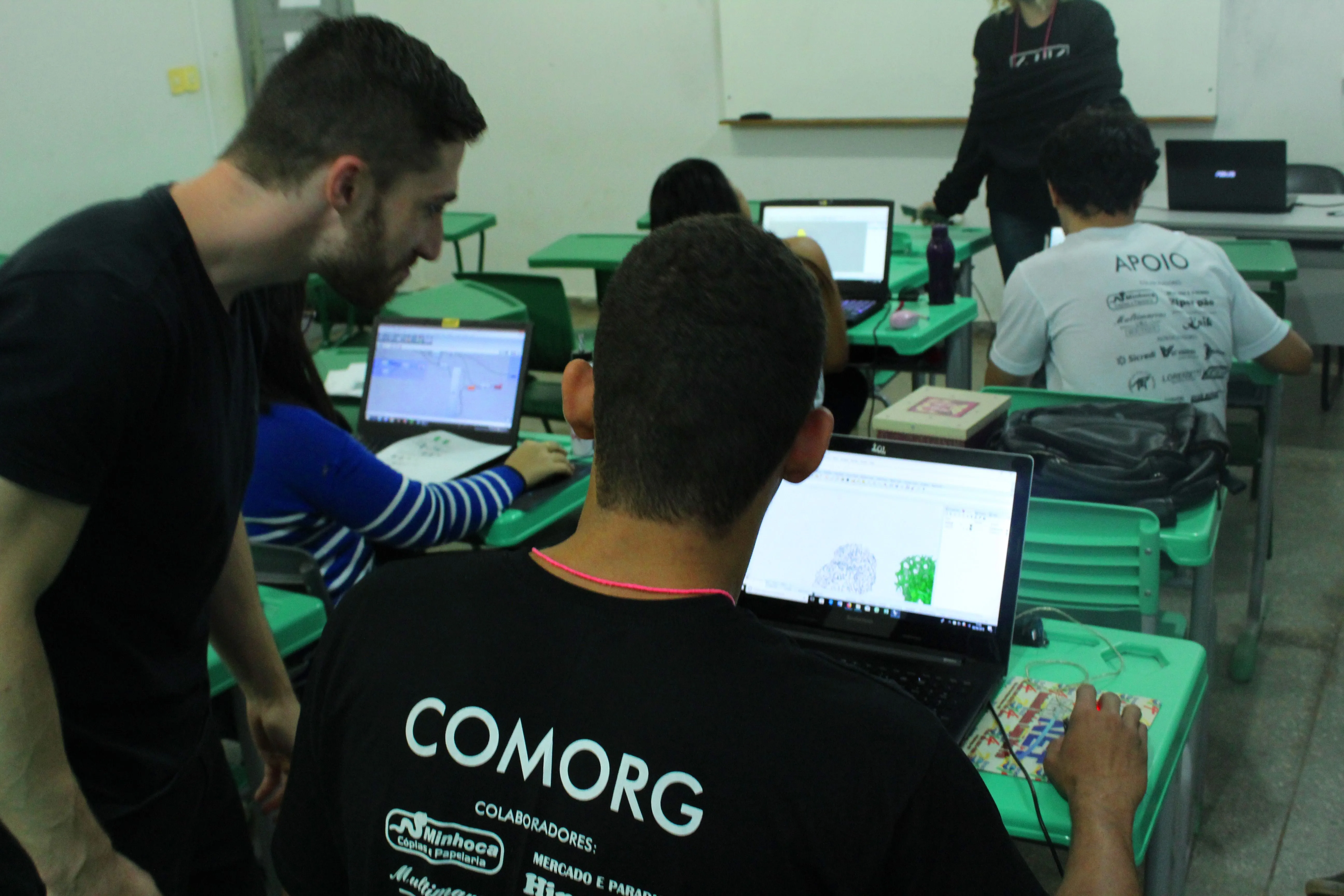 Daniel Nunes Locatelli helping a student refine their Exoskeleton model.