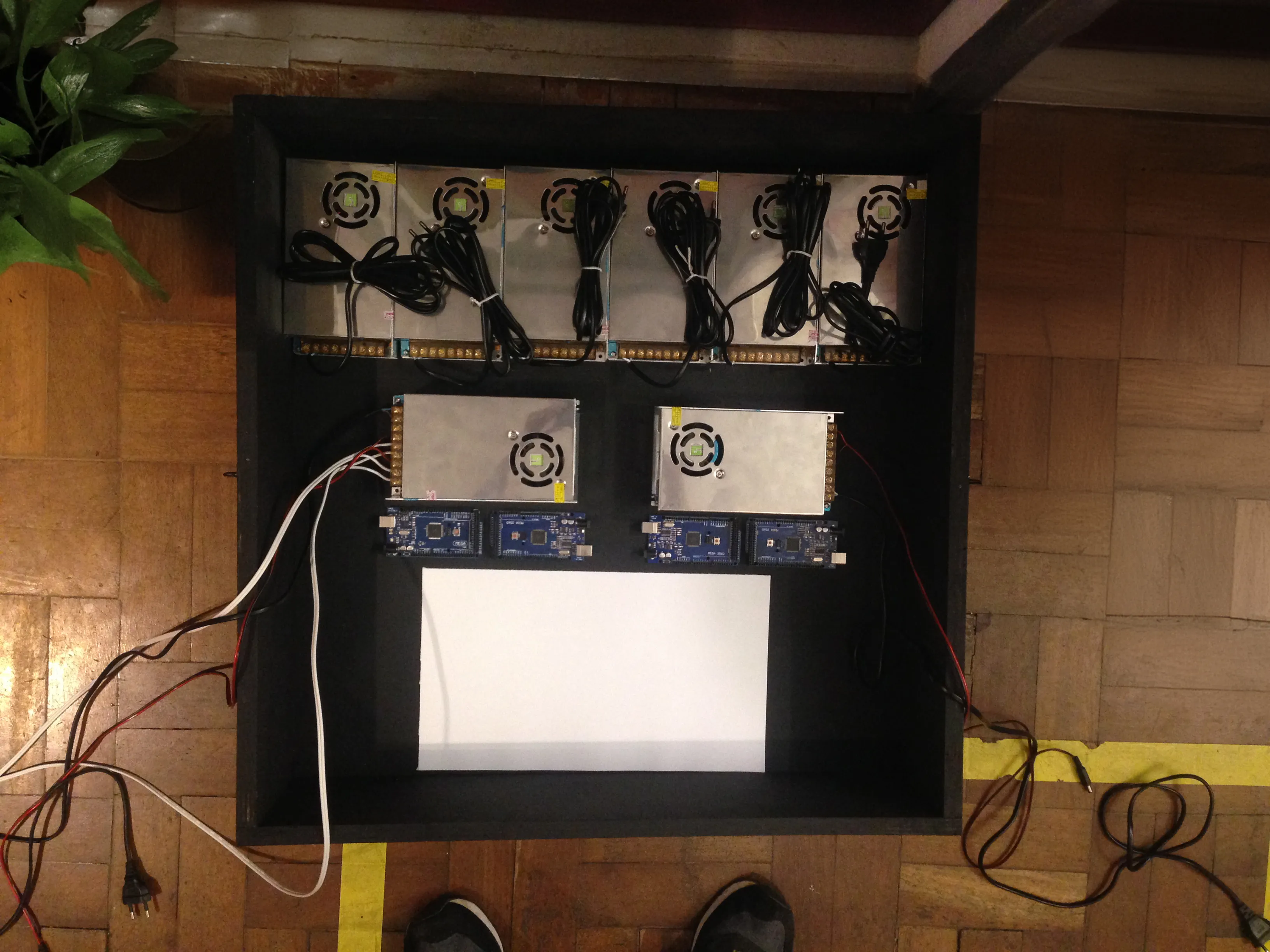 Photo of the control box: eight power supplies, four Arduino Mega, and space for an emergency battery.
Control box, the white paper represents the space left for the emergency battery.